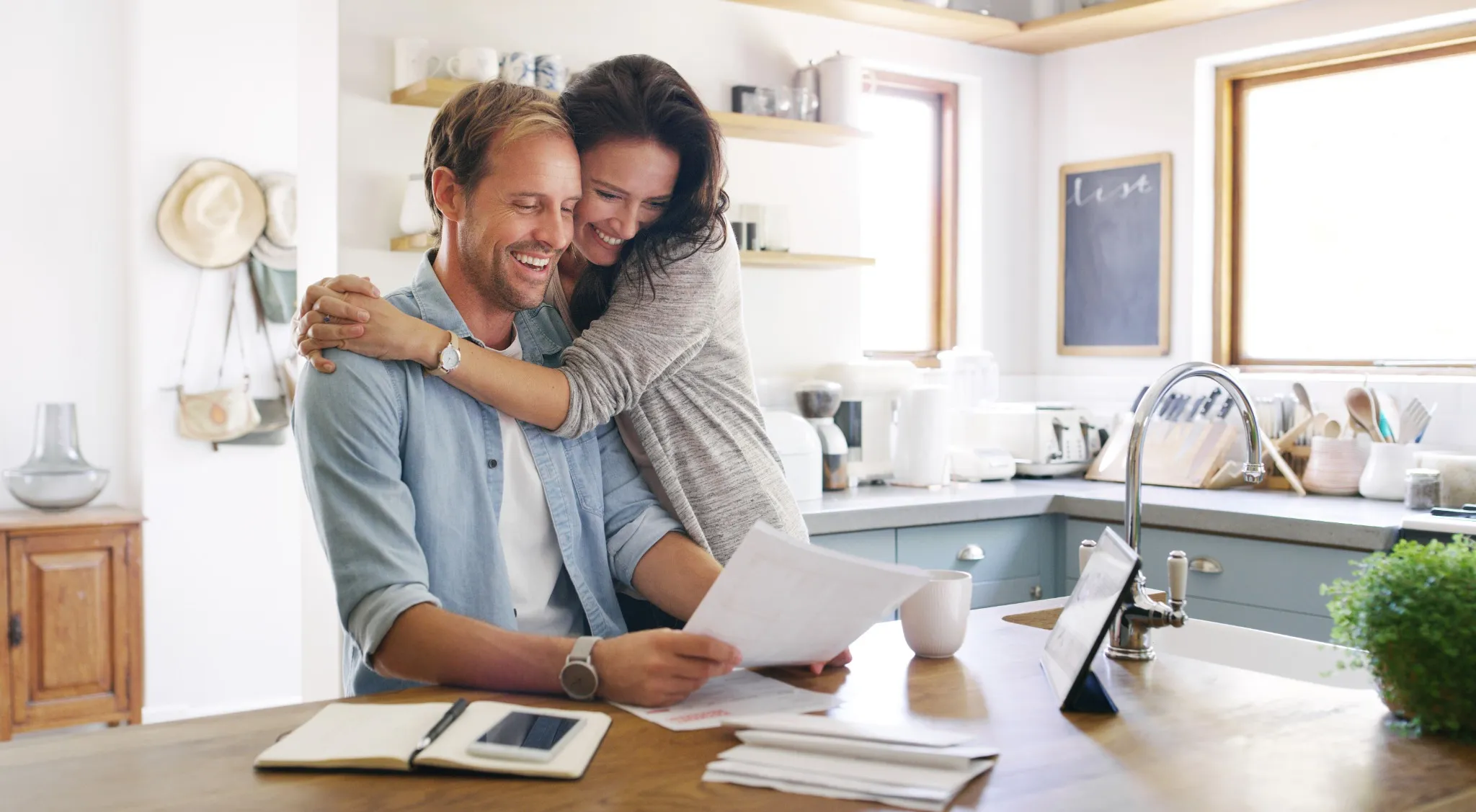 Happy couple reading paperwork