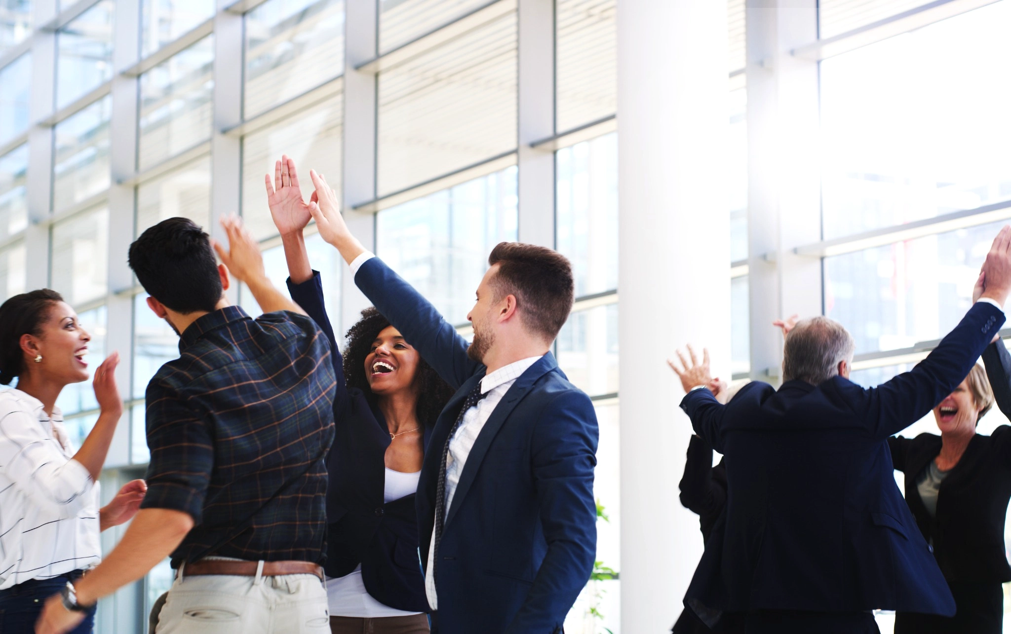 business team high fiving