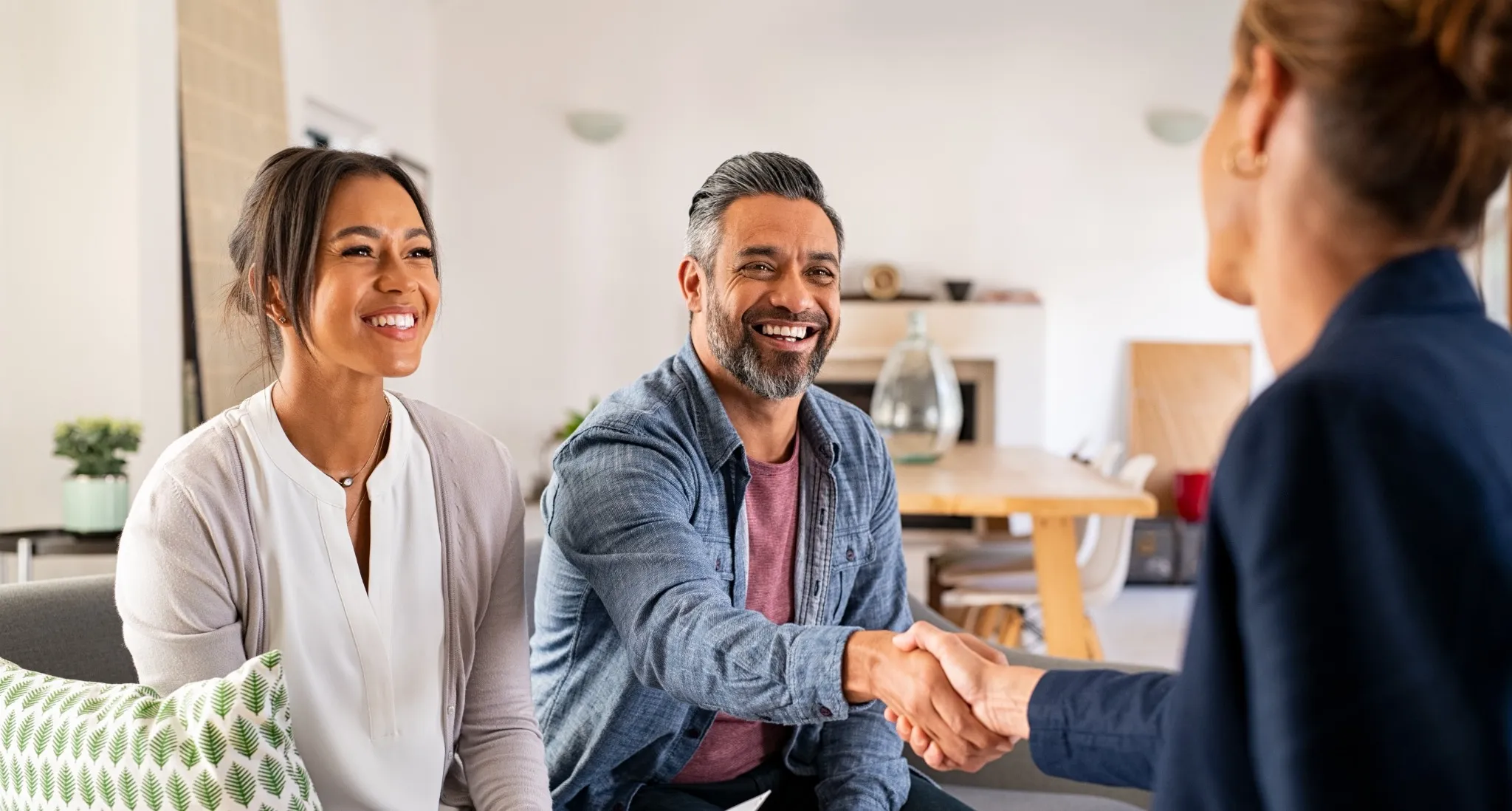 Couple shaking hands with professional and smiling